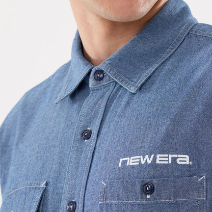 The model is wearing this New Era Originators Chambray Short Sleeve Shirt in dark blue. 4