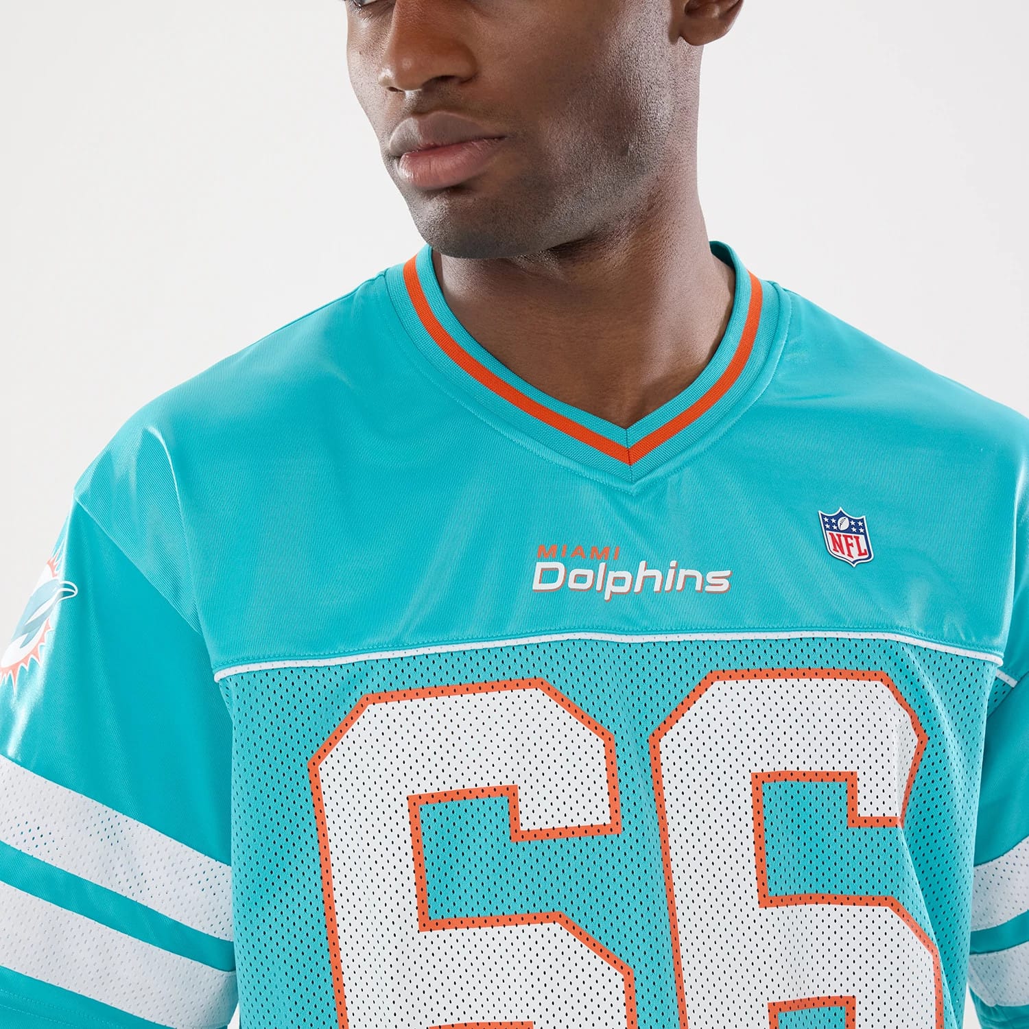 The model is wearing this NFL Miami Dolphins Mesh Jersey in turquoise. 6