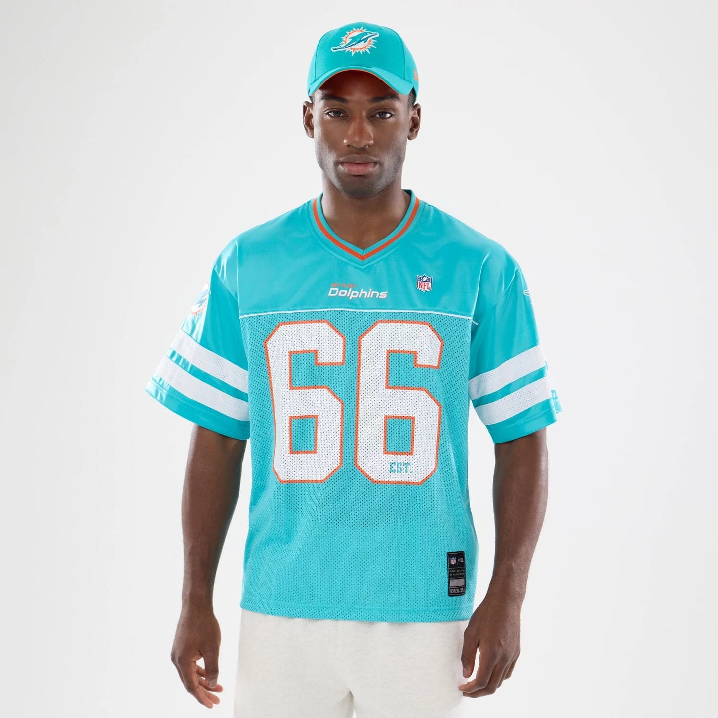 The model is wearing this NFL Miami Dolphins Mesh Jersey in turquoise. 1