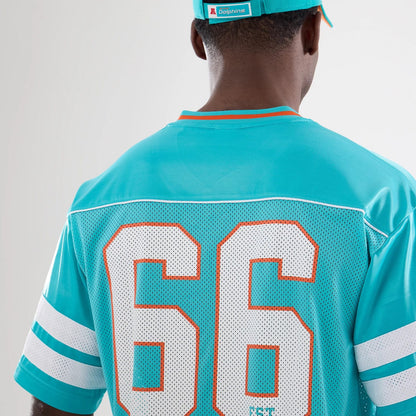 The model is wearing this NFL Miami Dolphins Mesh Jersey in turquoise. 5