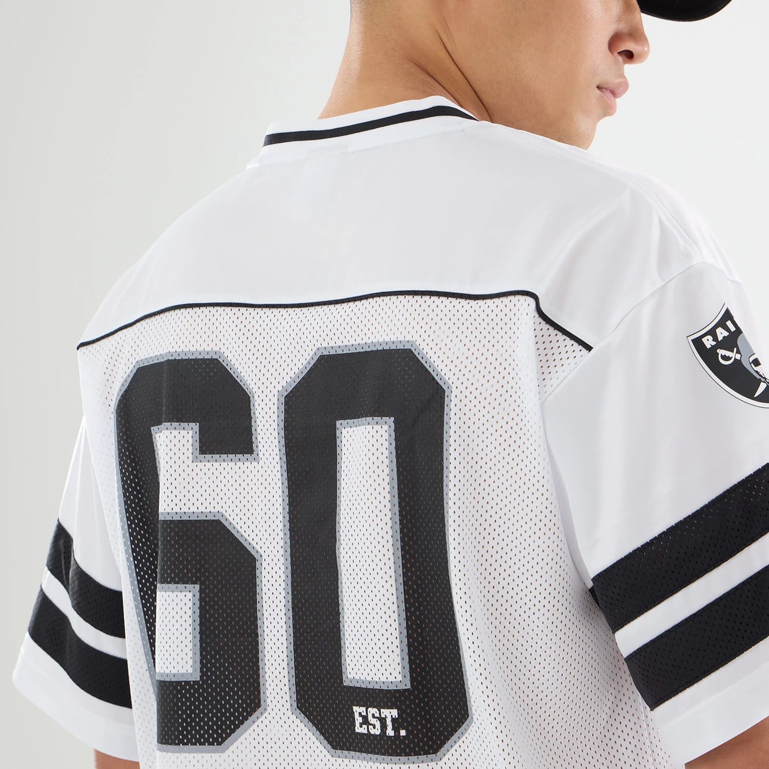 The model is wearing this NFL Las Vegas Raiders Mesh Jersey in white. 5