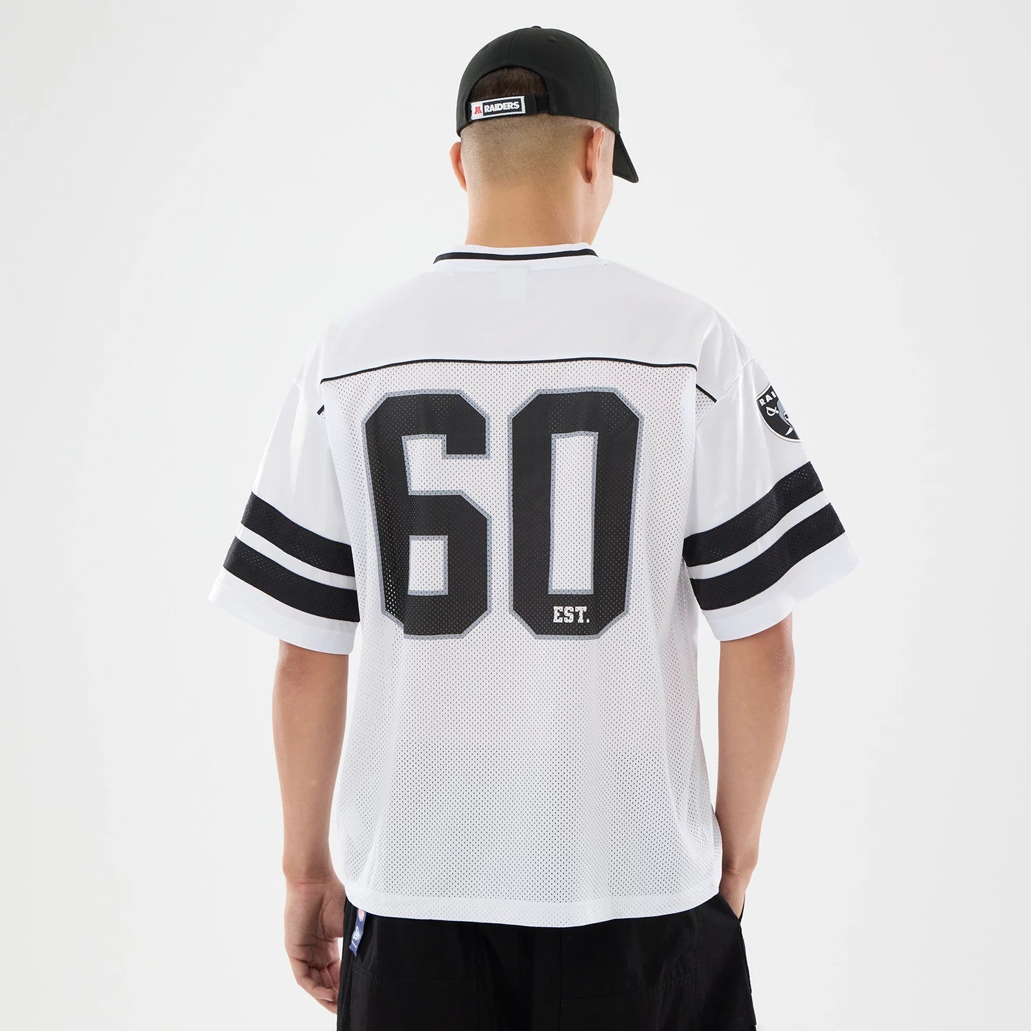 The model is wearing this NFL Las Vegas Raiders Mesh Jersey in white. 2