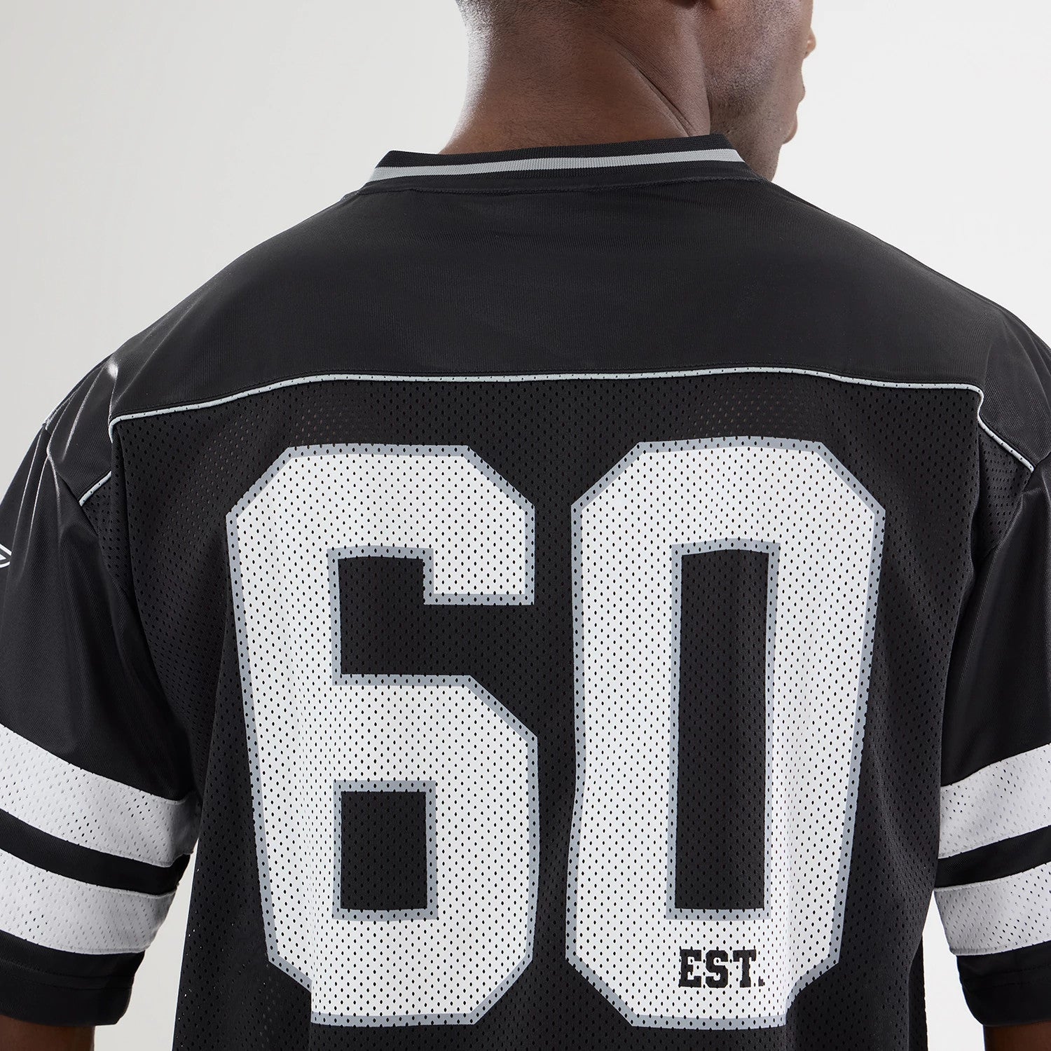 The model is wearing this NFL Dallas Cowboys Mesh Jersey in black. 4
