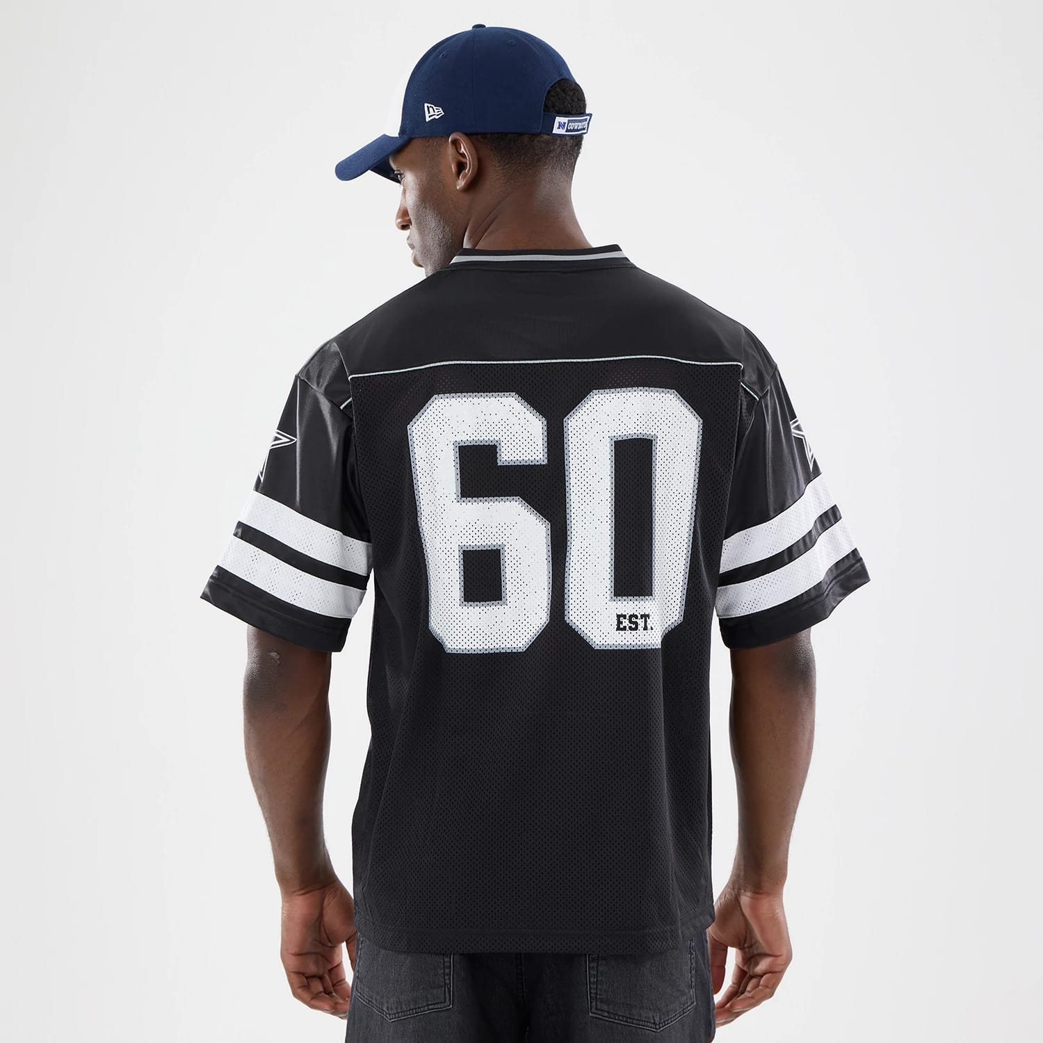 The model is wearing this NFL Dallas Cowboys Mesh Jersey in black. 2