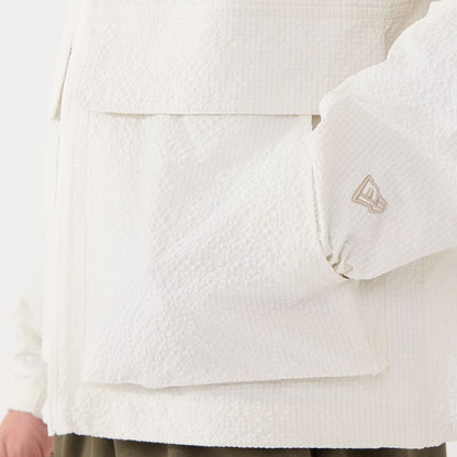 The model is wearing this New Era Black Label Jacket in open white. 5