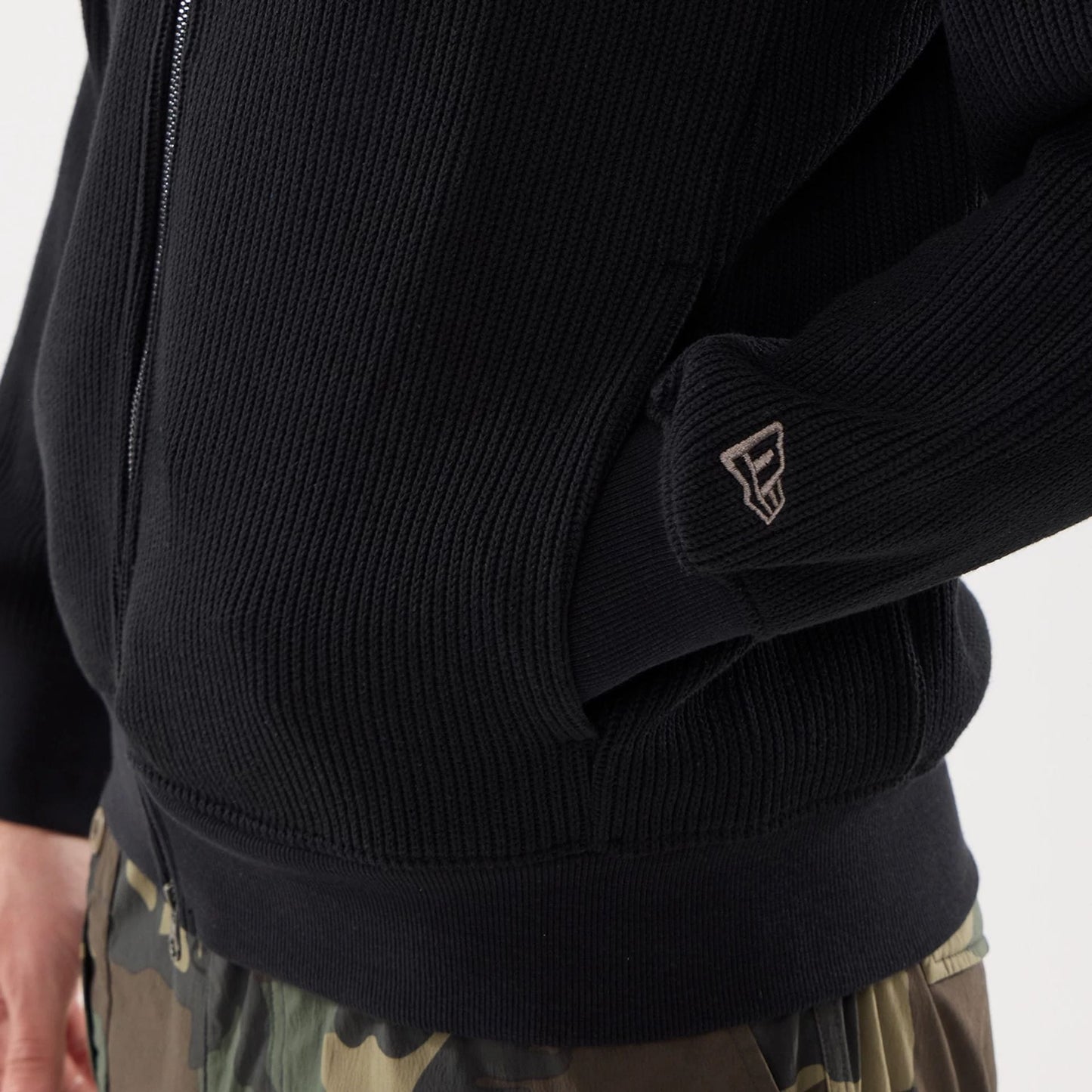 The model is wearing this New Era Black Label Jacket in black. 5