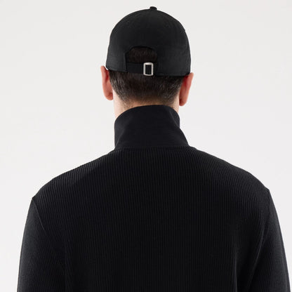 The model is wearing this New Era Black Label Jacket in black. 7