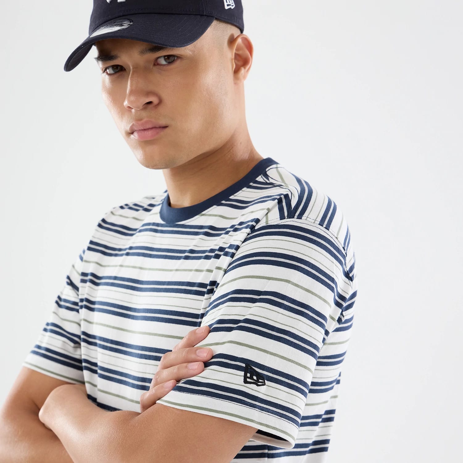 The model is wearing this New Era Boarder Stripe T-Shirt in white. 6