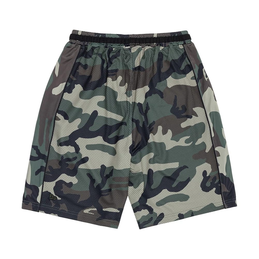The model is wearing this New Era Bermuda Oversized Shorts in 6 Day Camo. 6