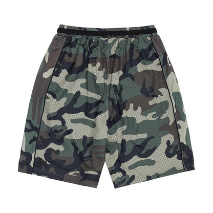 The model is wearing this New Era Bermuda Oversized Shorts in 6 Day Camo. 6