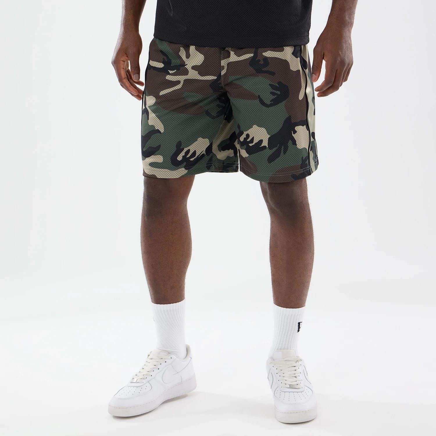 The model is wearing this New Era Bermuda Oversized Shorts in 6 Day Camo. 1