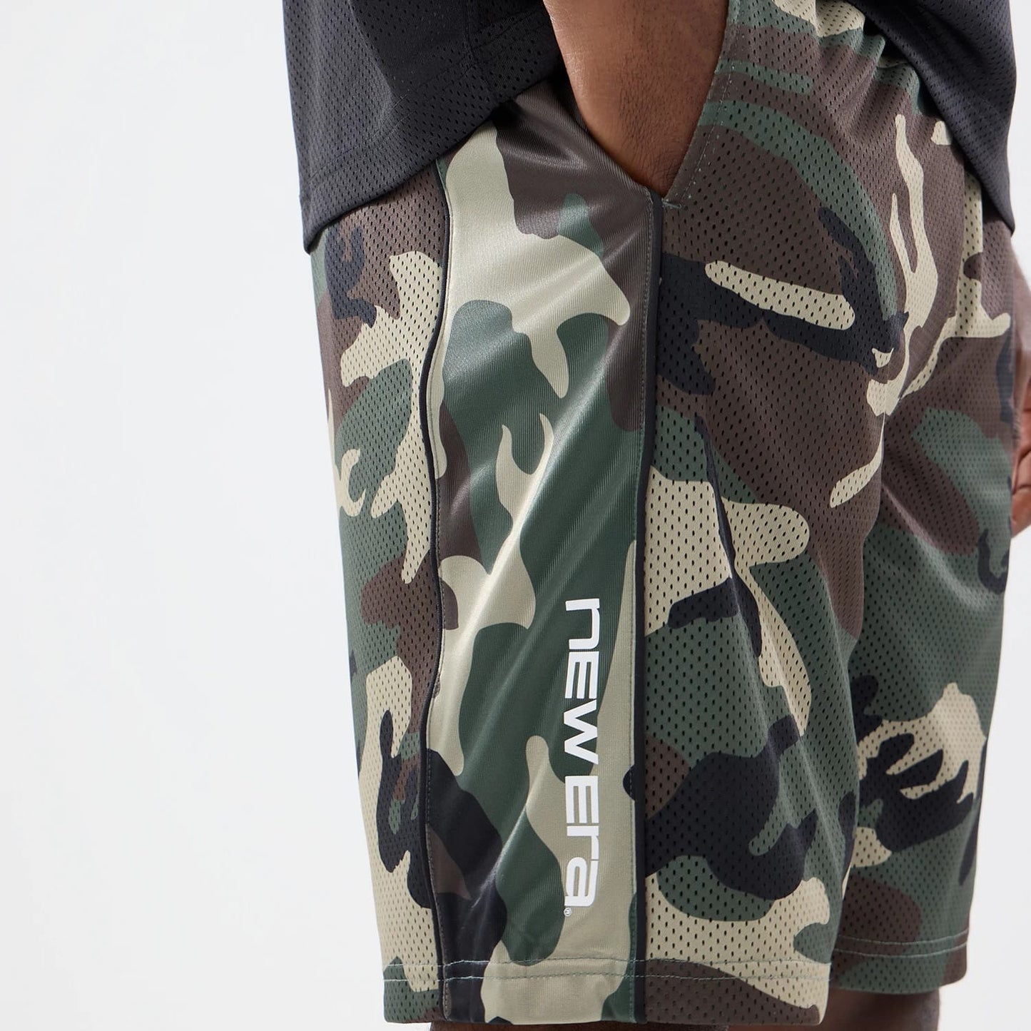 The model is wearing this New Era Bermuda Oversized Shorts in 6 Day Camo. 3
