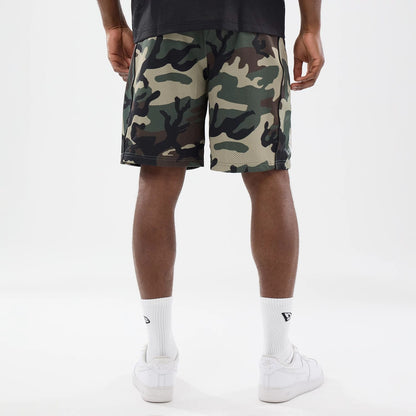 The model is wearing this New Era Bermuda Oversized Shorts in 6 Day Camo. 2