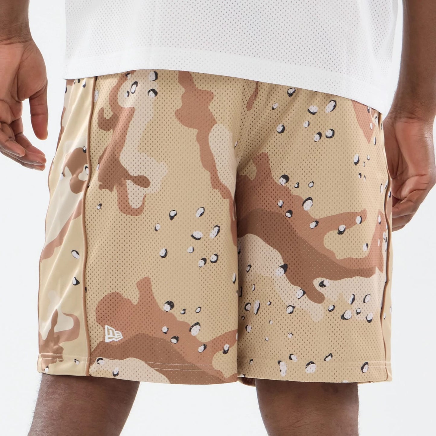 The model is wearing this New Era Bermuda Oversized Shorts in Woodland Camo. 5