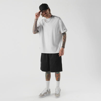 The model is wearing this New Era Bermuda Oversized Shorts in black. 5