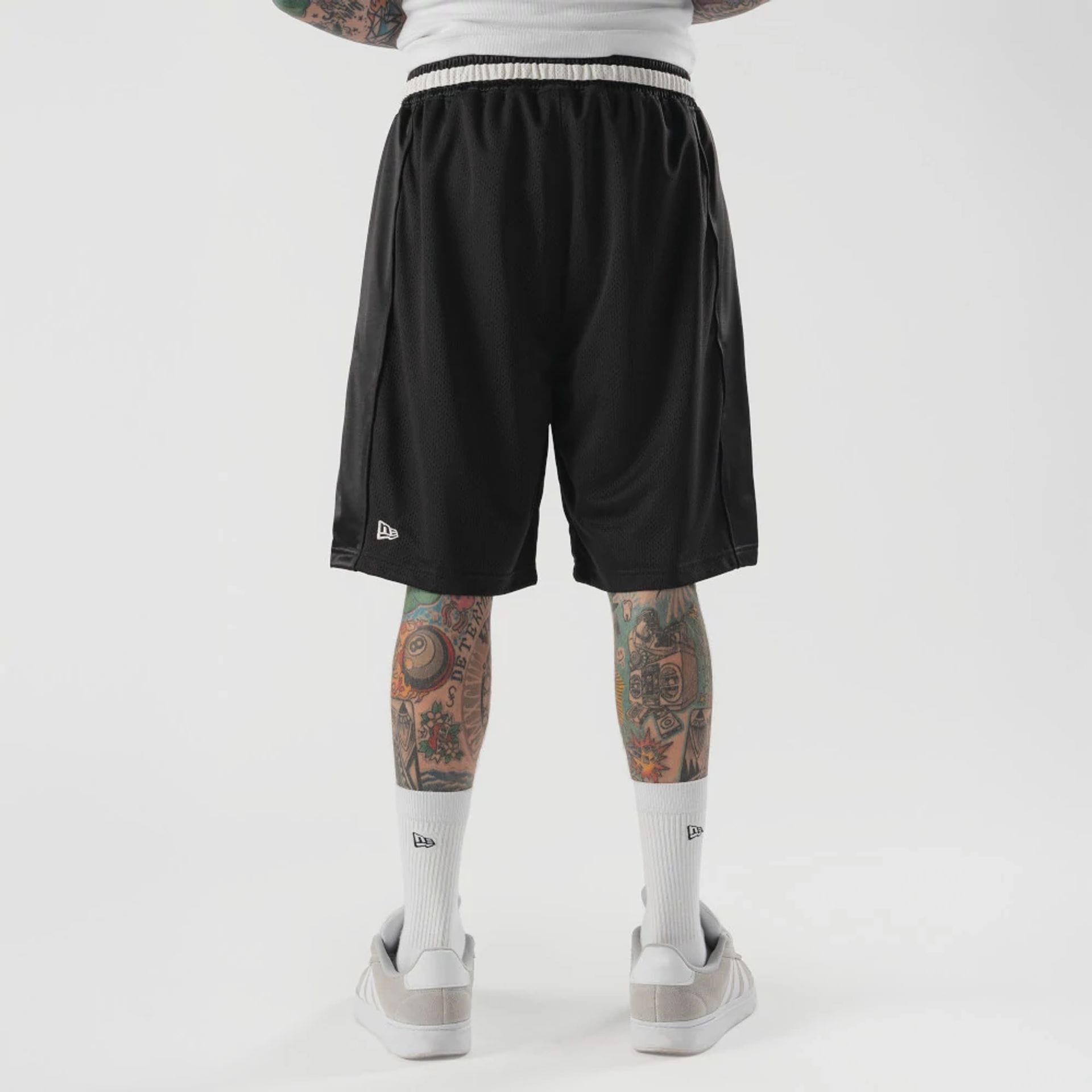 The model is wearing this New Era Bermuda Oversized Shorts in black. 2
