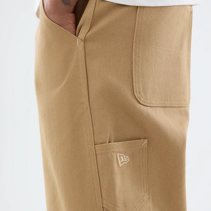 The model is wearing these New Era Work Pants in beige. 4