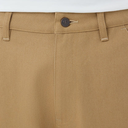 The model is wearing these New Era Work Pants in beige. 5