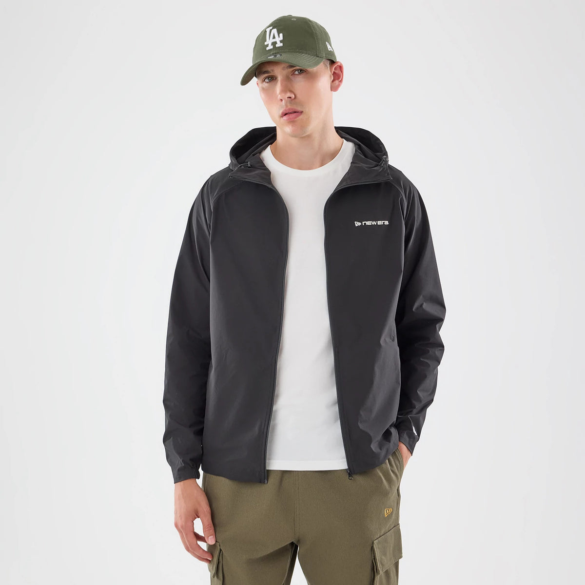 The model is wearing this New Era Windbreaker Jacket in black. 7