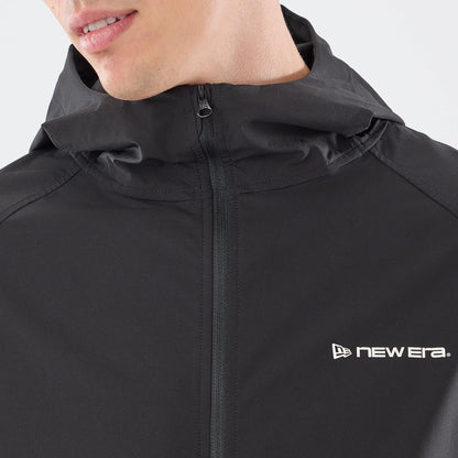 The model is wearing this New Era Windbreaker Jacket in black. 4