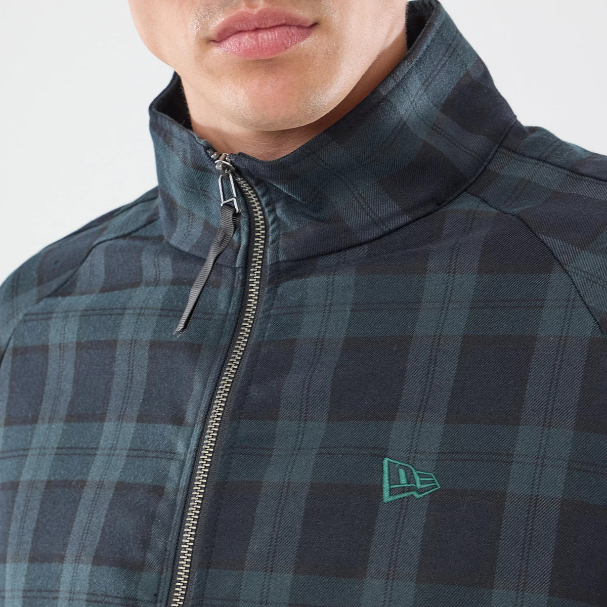 The model is wearing this New Era Blouson Plaid Windbreaker Jacket in Navy. 3