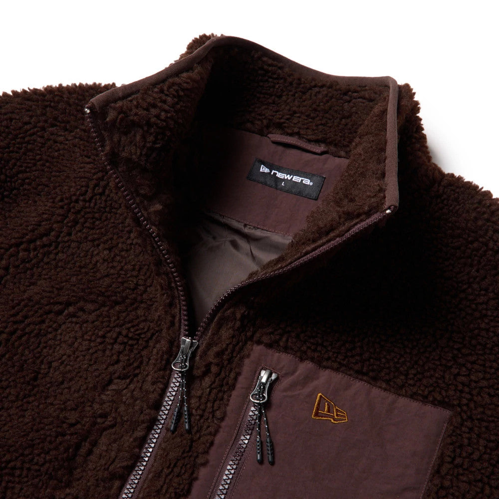 The model is wearing this New Era Blouson Jacket in dark brown. 3