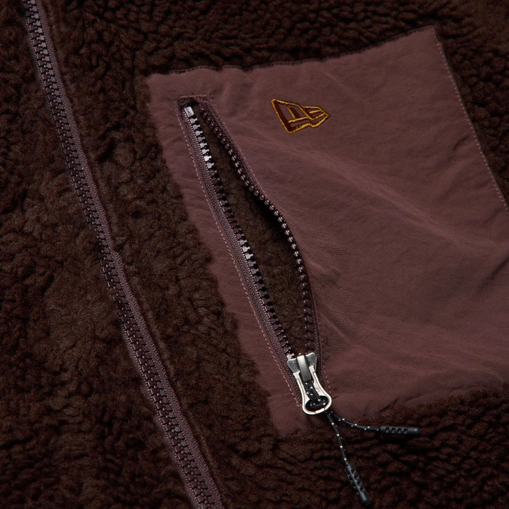 The model is wearing this New Era Blouson Jacket in dark brown. 4