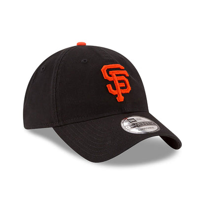 San Francisco Giants MLB Core Classic Black New Era 9TWENTY Adjustable Cap, three-quarter view showing the raised orange SF logo on the front panel, with a top button in matching orange and a grey 9TWENTY size sticker on the black curved visor.