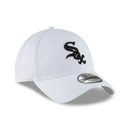 MLB Core Classic Chicago White Sox White New Era 9TWENTY Adjustable Cap, three-quarter view with a black embroidered Sox logo on the front panel, curved visor and 9TWENTY size sticker placed on top of the white visor.