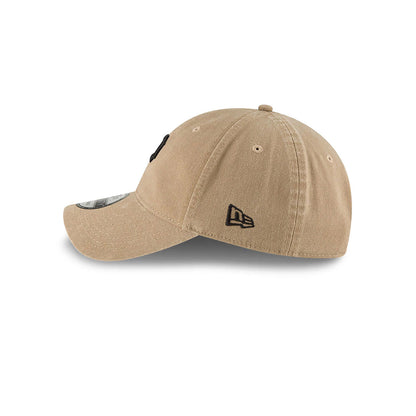 Pittsburgh Pirates MLB Core Classic Beige New Era 9TWENTY Adjustable Cap, side view showing the embroidered New Era flag logo on the left side of the unstructured beige crown, with a curved visor and 9TWENTY size sticker.