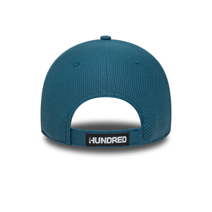 Oval Invincibles The Hundred 2025 Blue New Era 9FORTY Adjustable Cap, rear view showing the black and white The Hundred logo on a fabric strap with a buckle, centred beneath the structured blue crown.