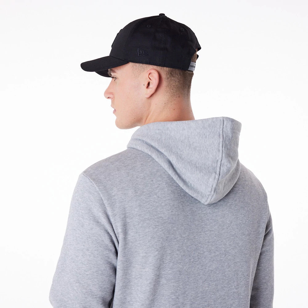 New Era New York Yankees MLB Regular Grey Pullover Hoodie, on-model view from the back showing the light grey hoodie with the hood down, worn with a black cap featuring a raised New Era logo on the side panel.
