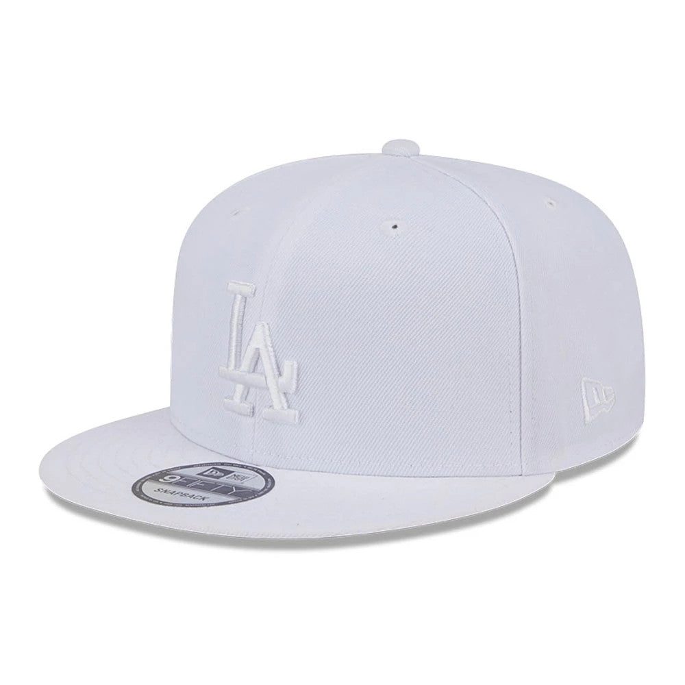 LA Dodgers MLB Evergreen White New Era 9FIFTY Snapback Adjustable Cap, three-quarter view showing the raised white LA logo on the front panel, the white New Era flag logo on the left side, and the 9FIFTY size sticker on the flat visor.