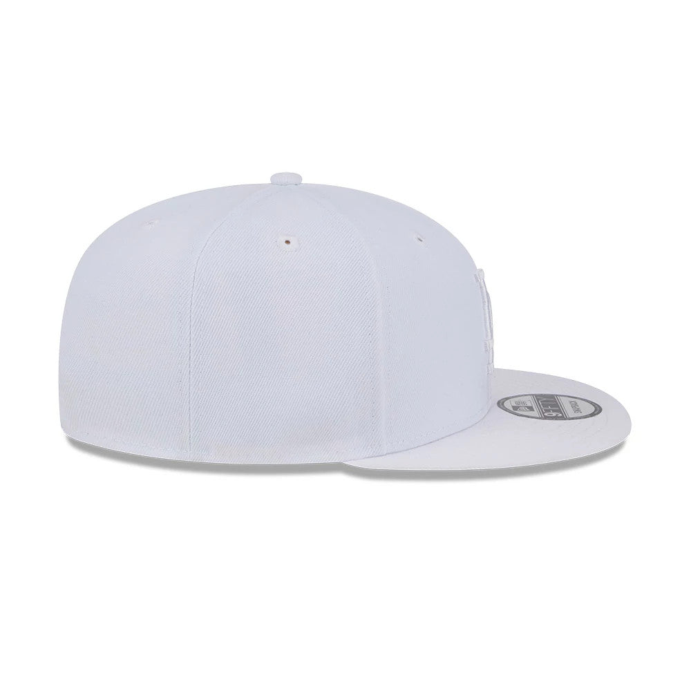 LA Dodgers MLB Evergreen White New Era 9FIFTY Snapback Adjustable Cap, side view showcasing the structured crown and flat visor with silver and black 9FIFTY size sticker, top button and matching white eyelets.