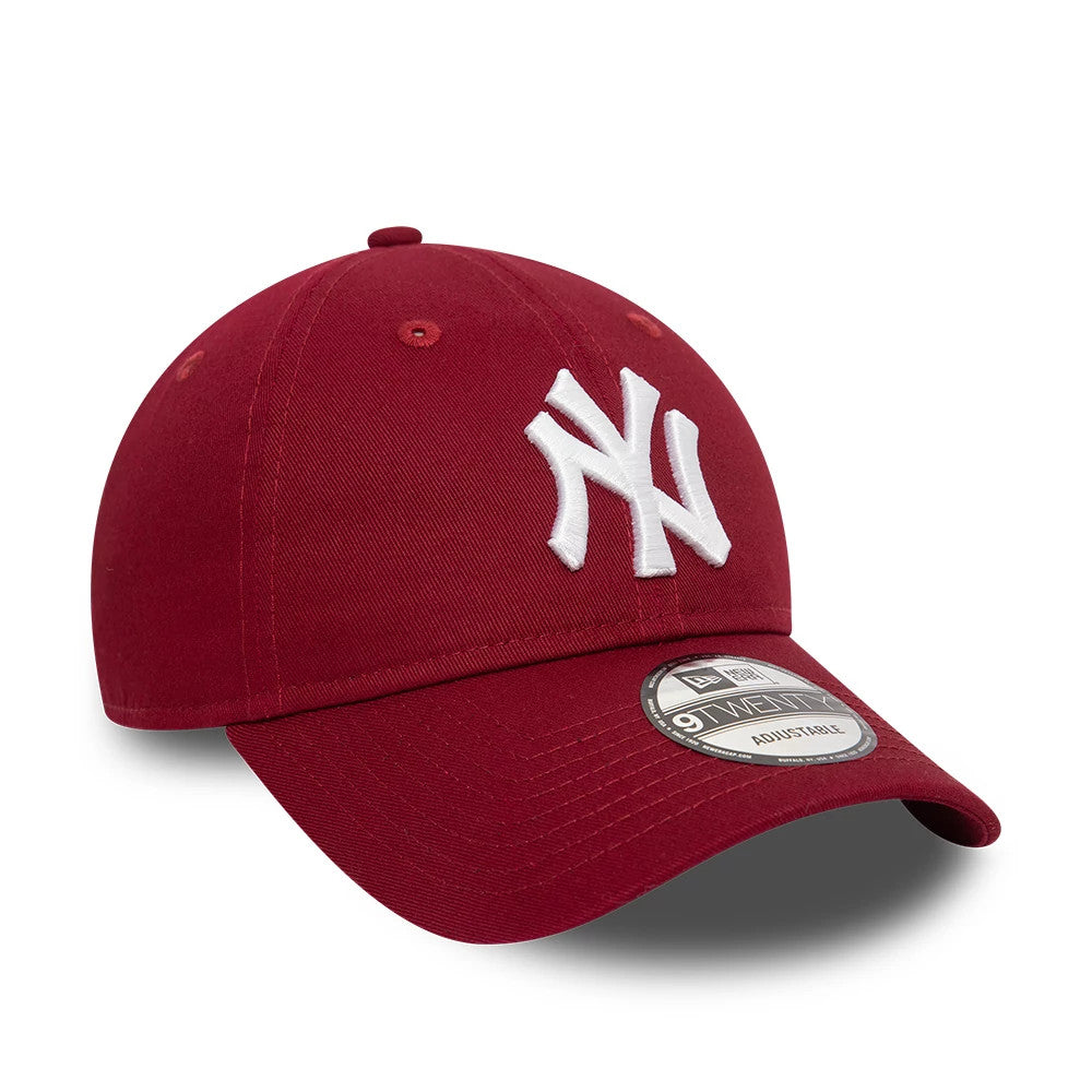 New York Yankees League Essential Dark Red New Era 9TWENTY Adjustable Cap, three-quarter view showing the white raised embroidered NY logo on the front panel, with a curved visor and a 9TWENTY size sticker.