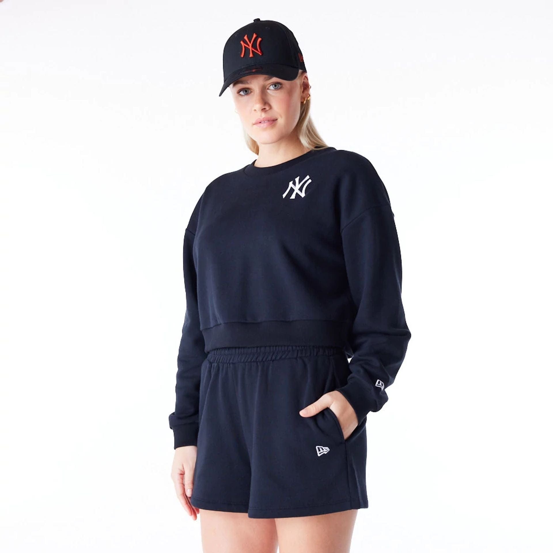 The Female model is wearing New York Yankees Womens MLB League Essential Black Crop Crew Neck Sweatshirt 1