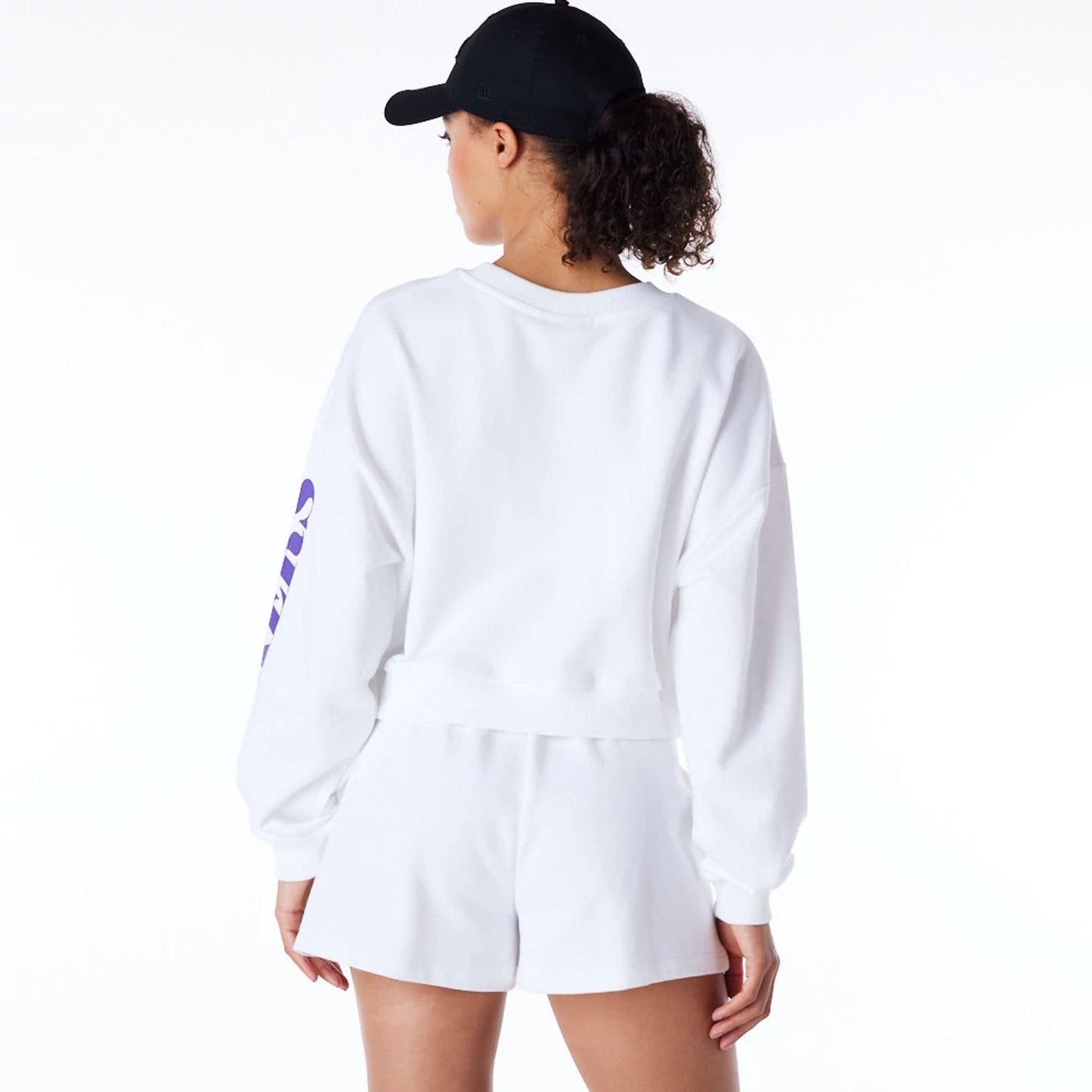 The Female model is wearing LA Lakers Womens NBA Wordmark White Crop Crew Neck Sweatshirt 2
