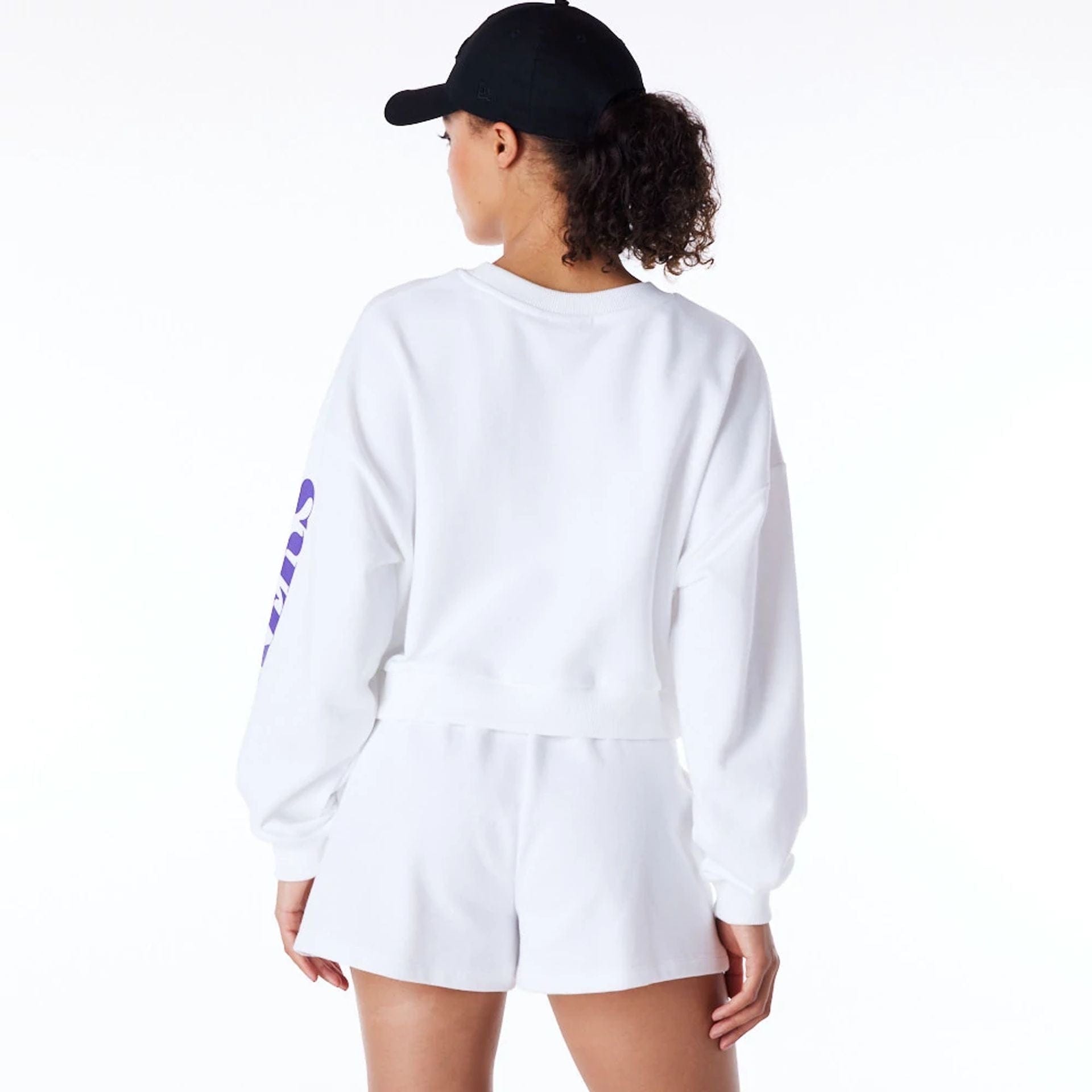 The Female model is wearing LA Lakers Womens NBA Wordmark White Crop Crew Neck Sweatshirt 2