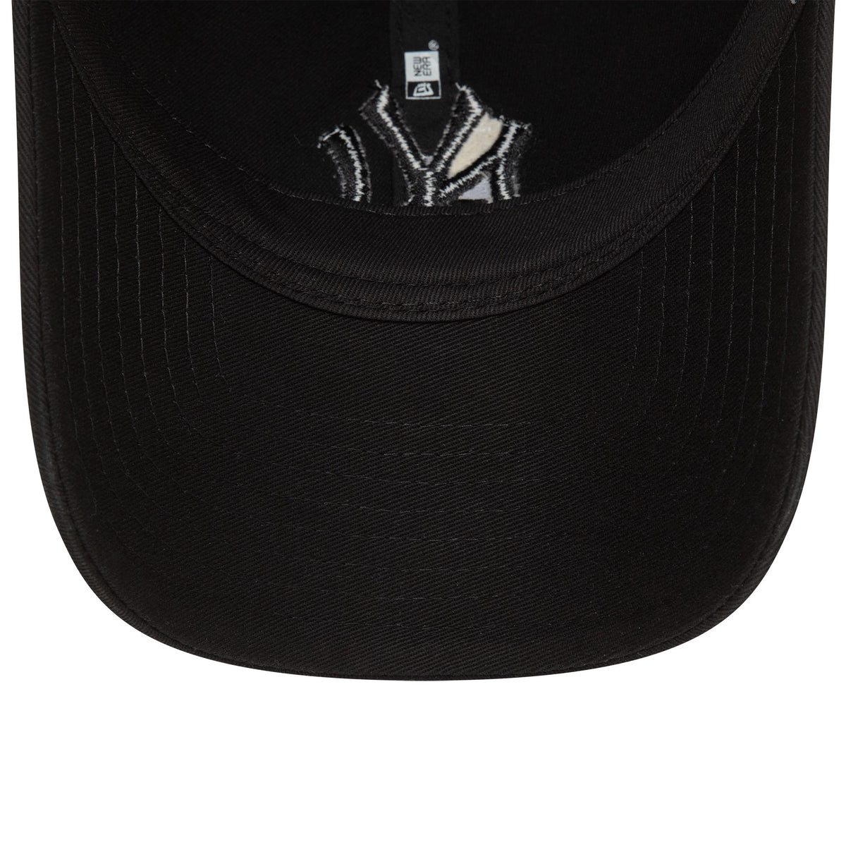 New York Yankees Washed Black New Era 9TWENTY Adjustable Cap, inside view with black taping and sweatband, showing the underside of the black visor and an embroidered Yankees logo on the inner lining.