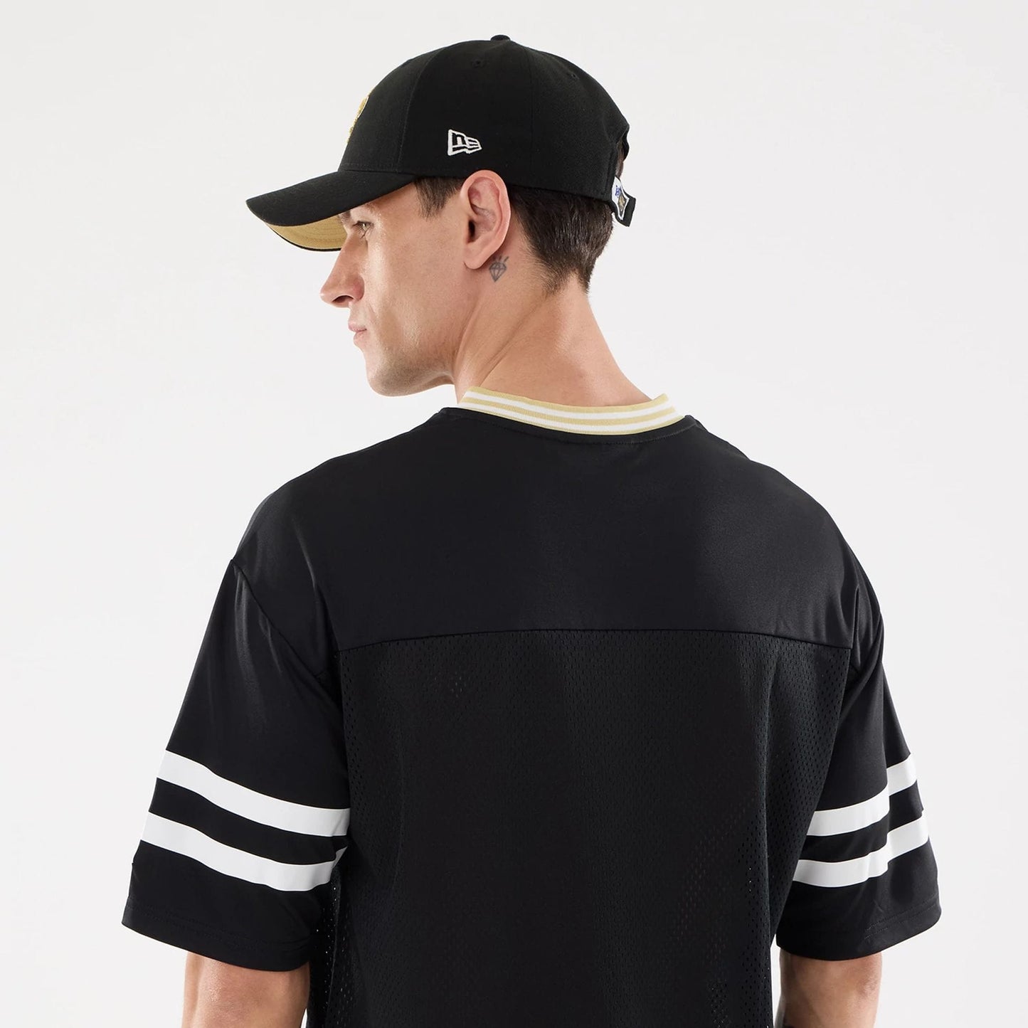 The Male model is wearing New Orleans Saints NFL Mesh Black Mesh Jersey 7