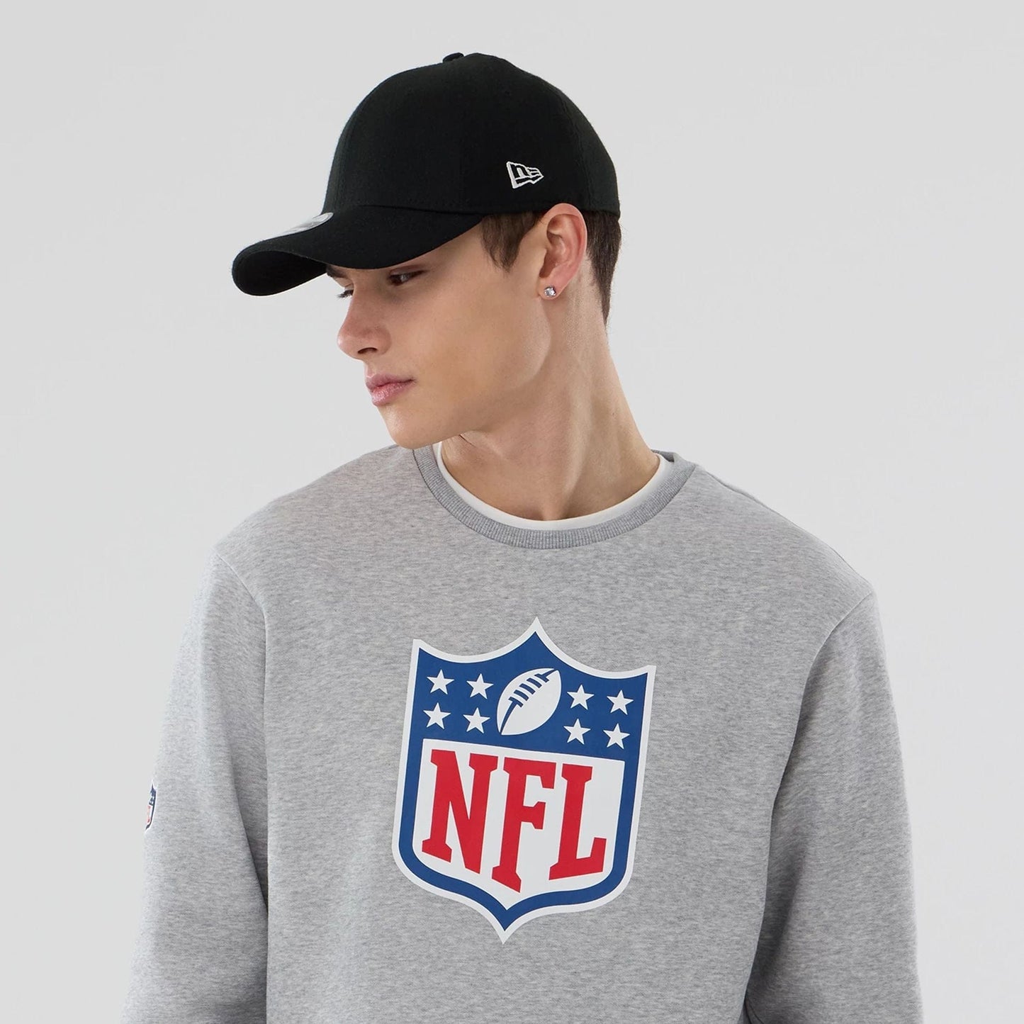The Male model is wearing NFL Generic Logo Grey Crew Neck Sweater 6