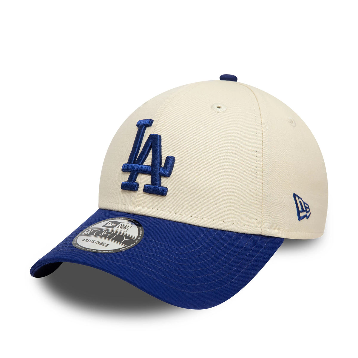 LA Dodgers Colour Block Cream New Era 9FORTY Adjustable Cap, three-quarter view showing the raised blue LA logo on the front panel, blue New Era flag logo on the left side, and a 9FORTY size sticker on the blue visor.