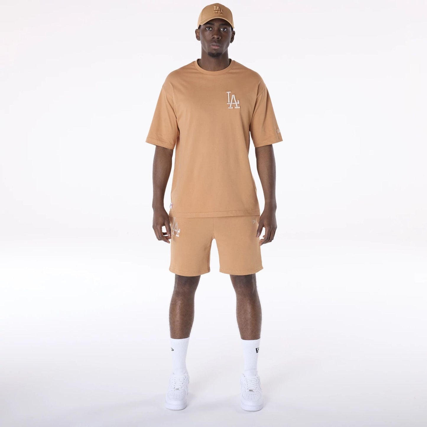 The Male model is wearing LA Dodgers MLB League Essential Dark Beige Shorts 8