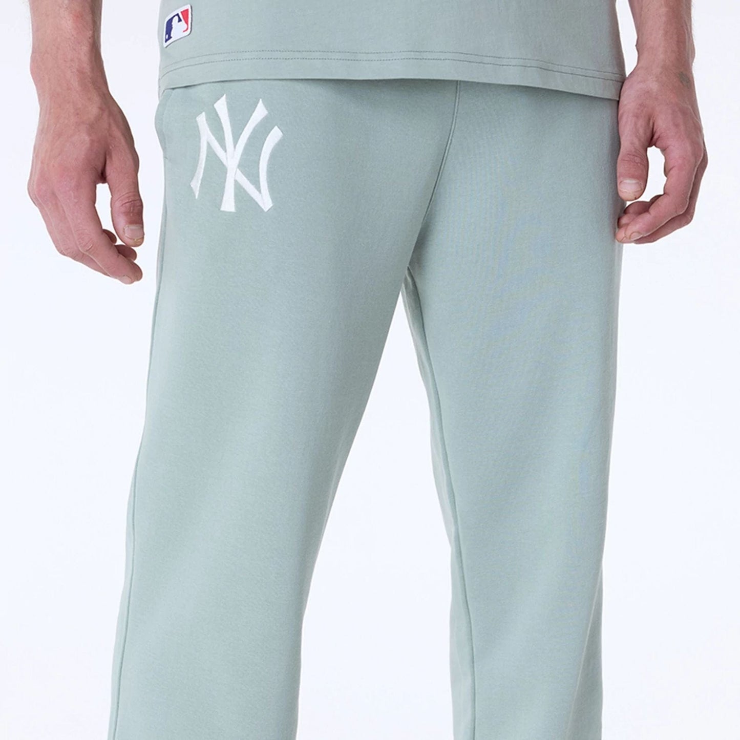 The Male model is wearing New York Yankees MLB League Essential Pastel Green Fleece Joggers 6