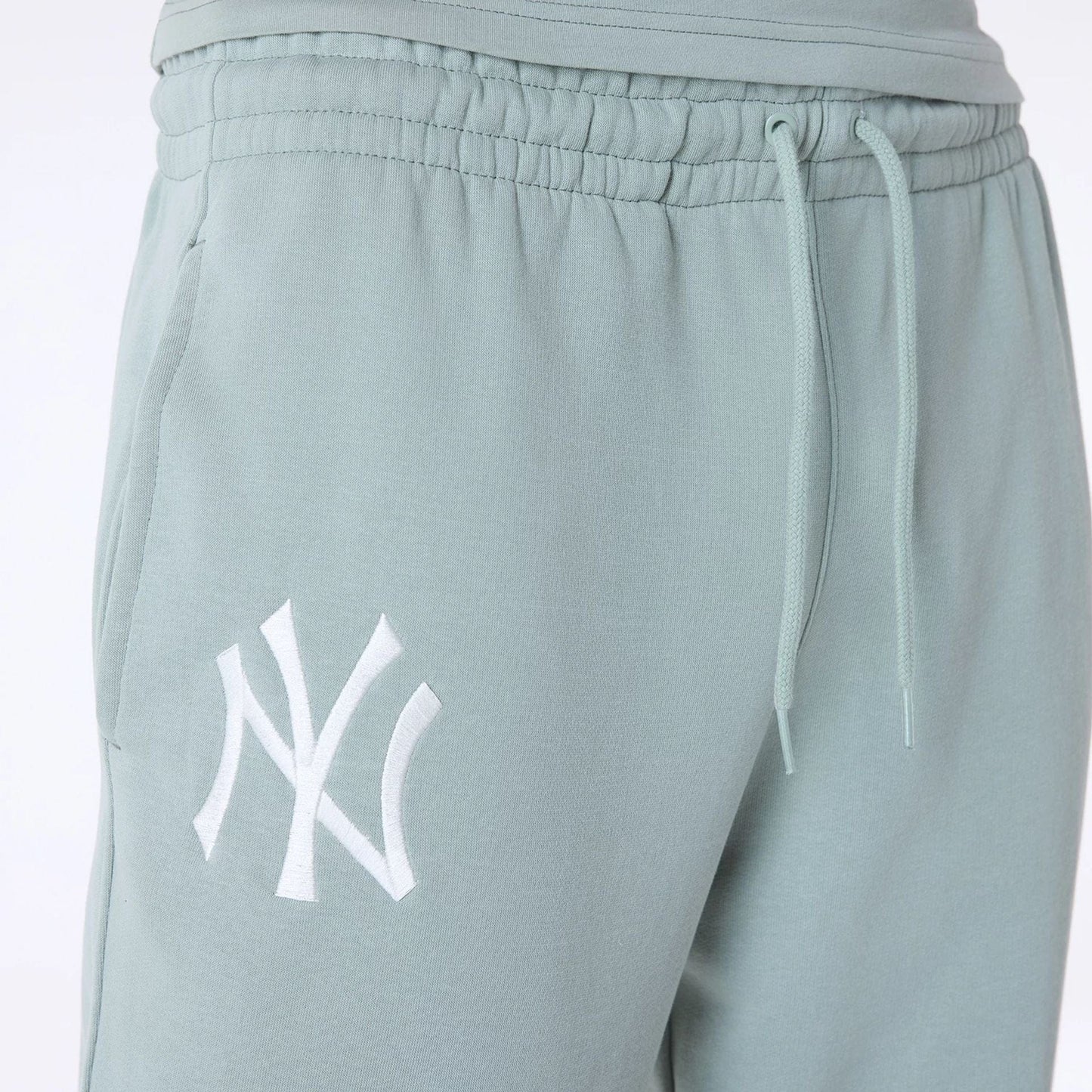 The Male model is wearing New York Yankees MLB League Essential Pastel Green Fleece Joggers 3