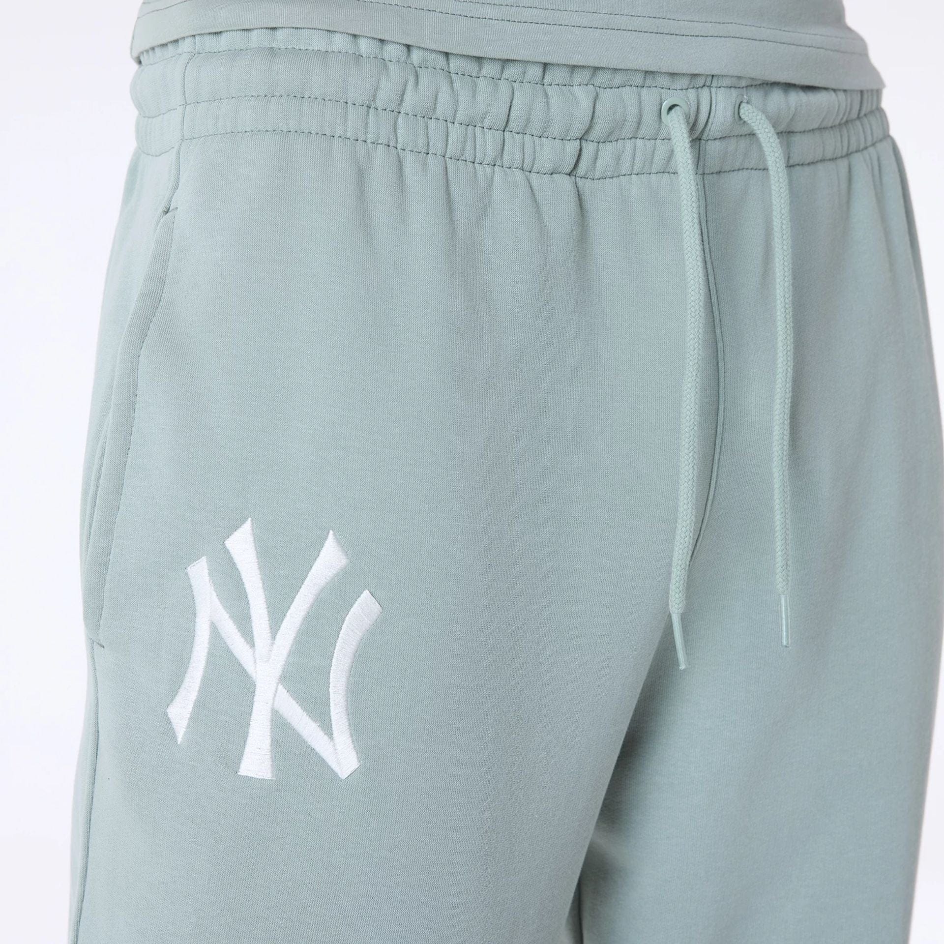 The Male model is wearing New York Yankees MLB League Essential Pastel Green Fleece Joggers 3