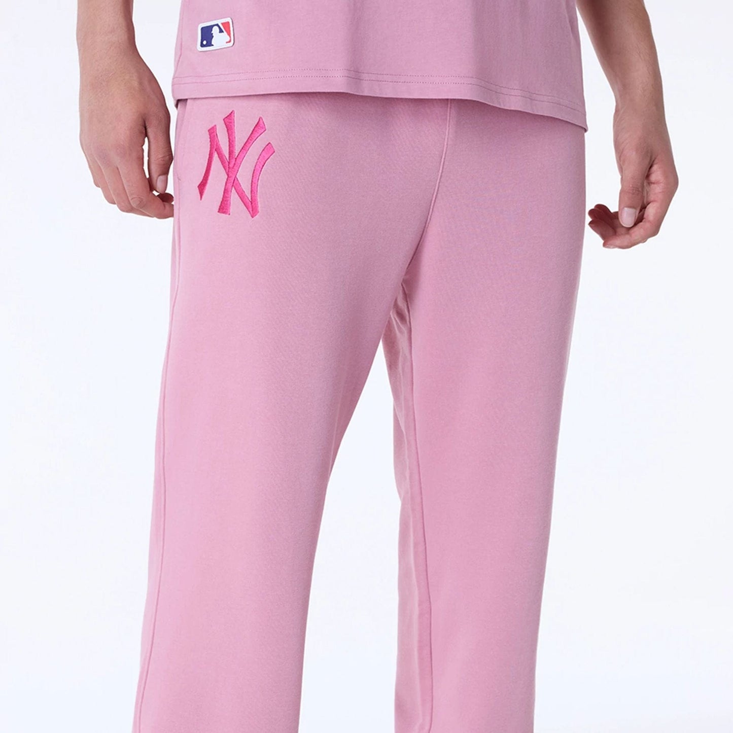 The Male model is wearing New York Yankees MLB League Essential Dark Pink Fleece Joggers 5