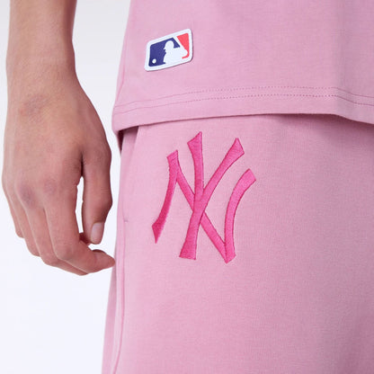 The Male model is wearing New York Yankees MLB League Essential Dark Pink Fleece Joggers 6