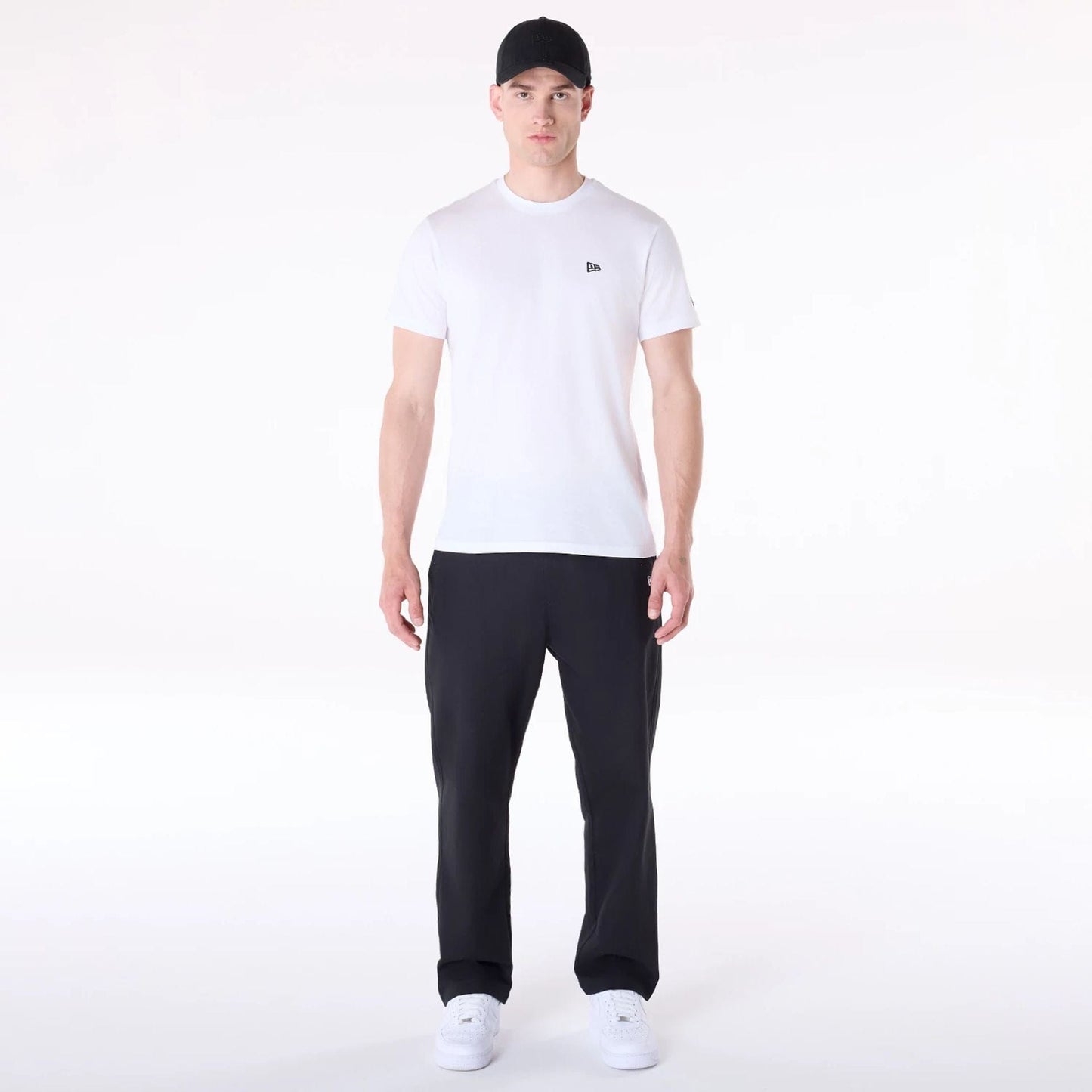 The Male model is wearing New Era Black Chino Trousers 4