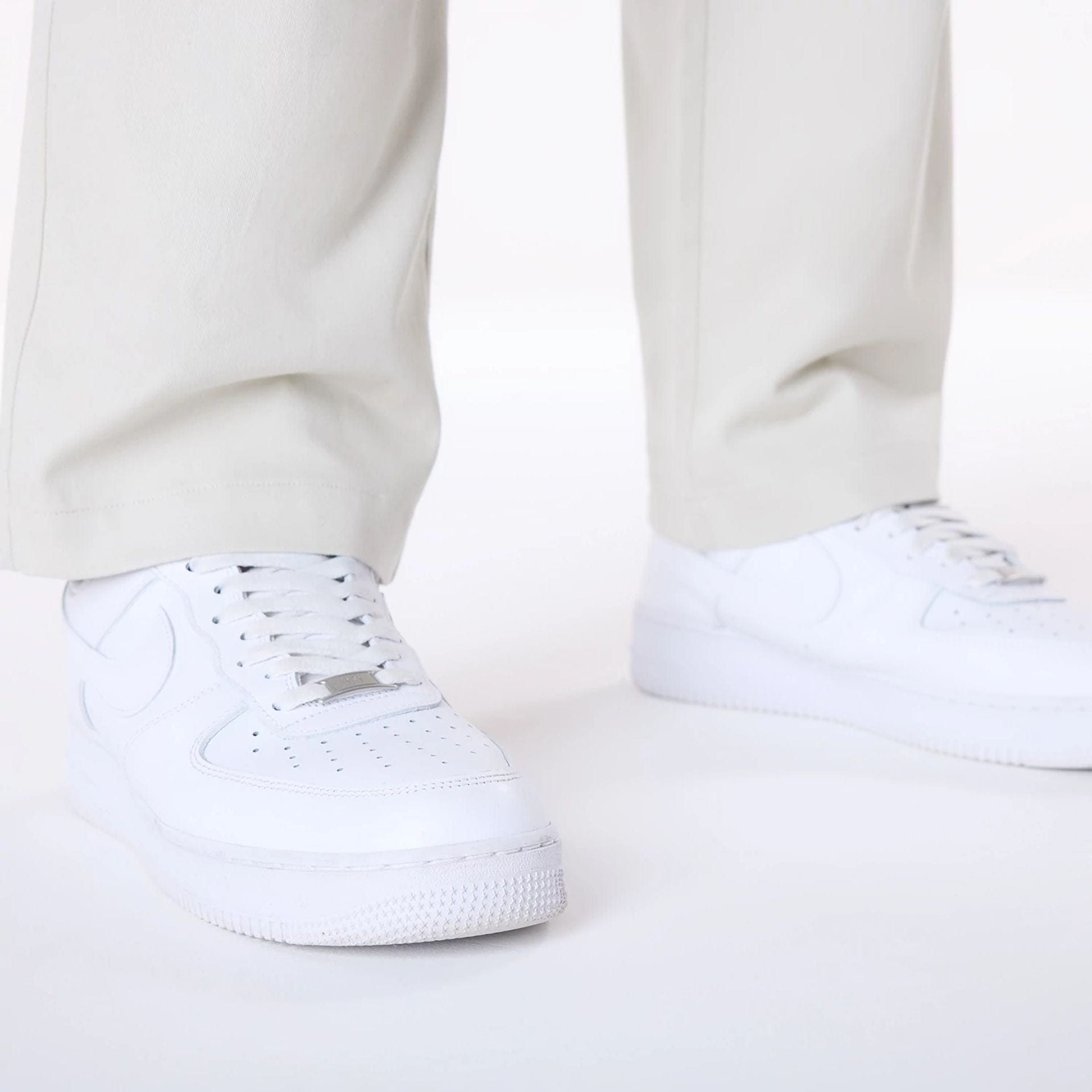 The Male model is wearing New Era Cream Chino Trousers 3